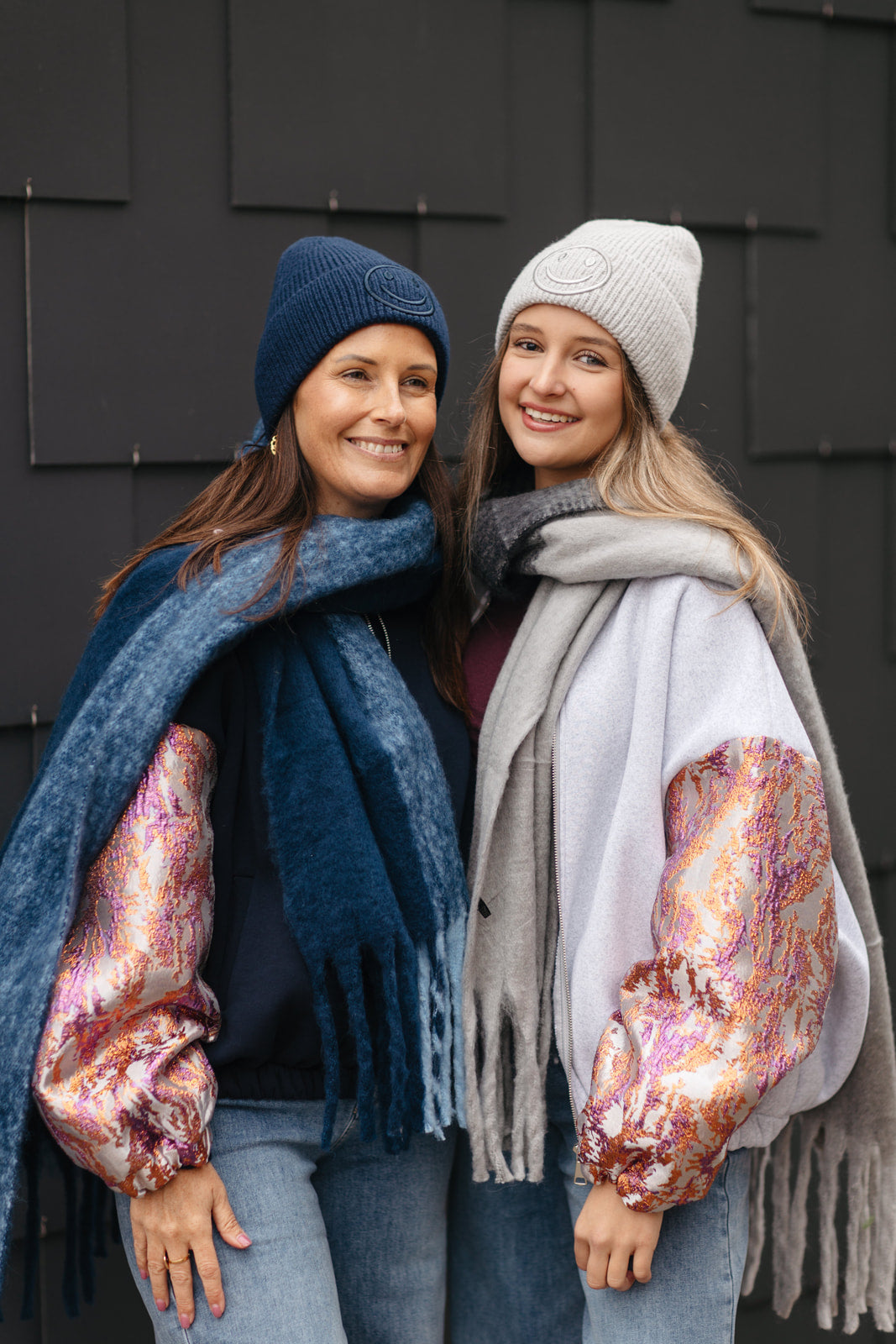 Marineblaue sweatervest met glanzende kleurrijke mouwen