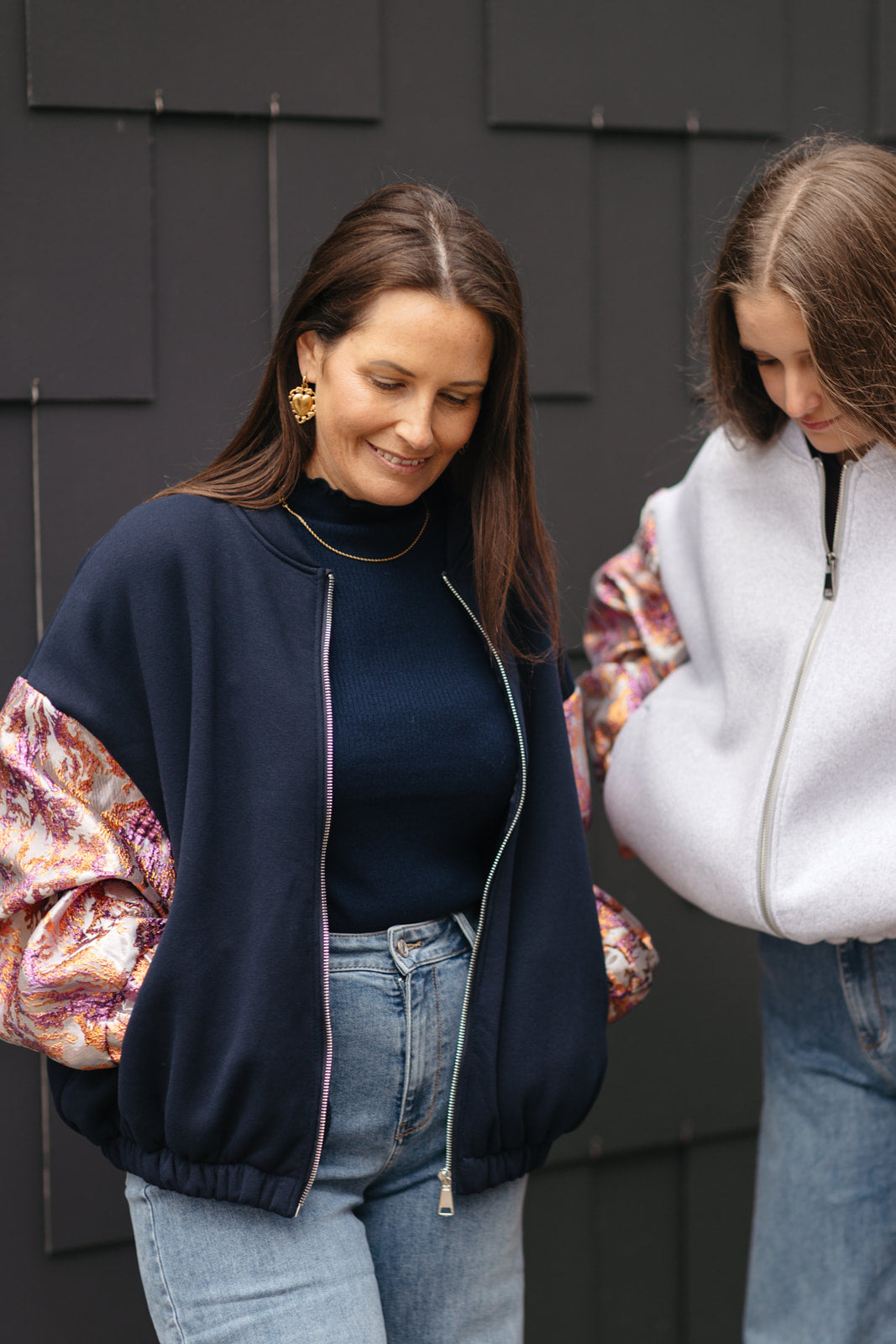 Marineblaue sweatervest met glanzende kleurrijke mouwen