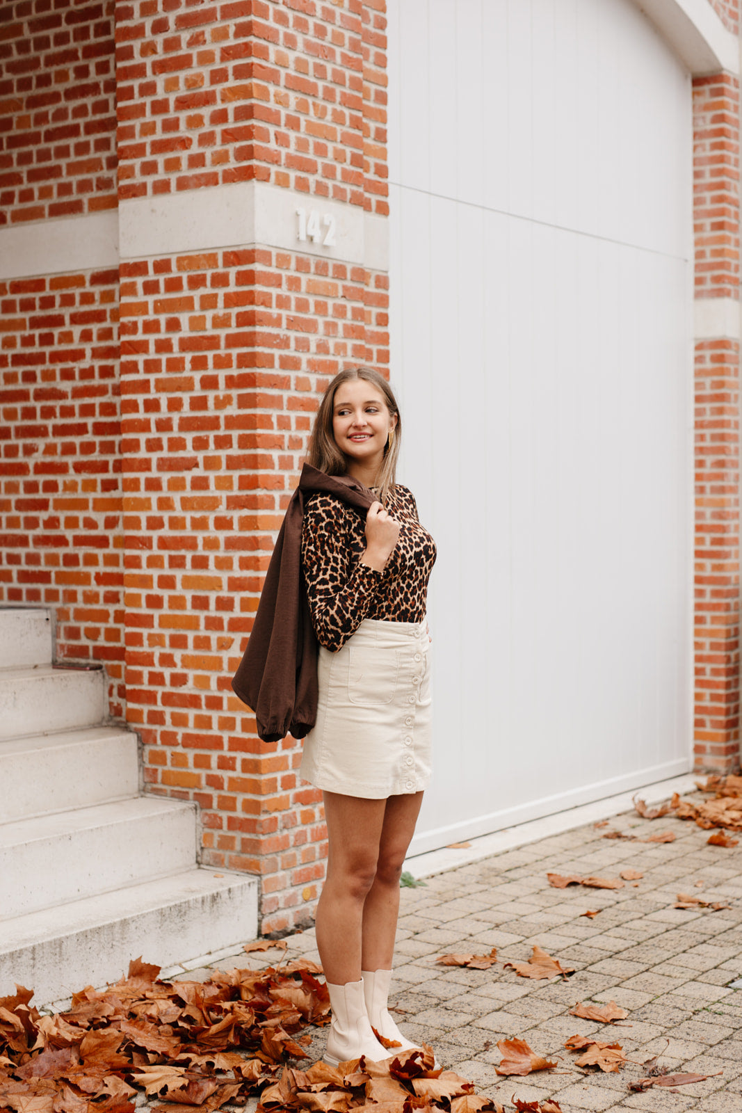 Beige kort rokje met knopen en zakken – vooraanzicht